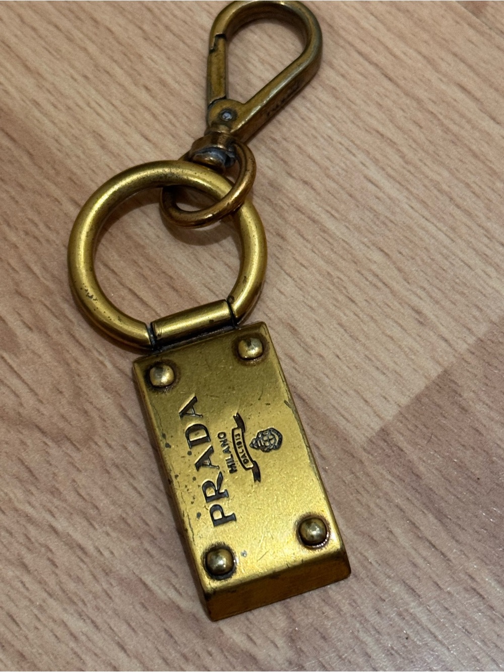 Vintage Prada Brass-Tone Logo Keychain in Gold